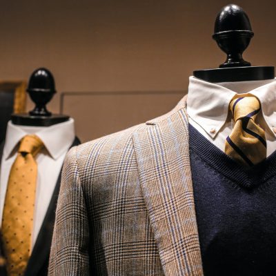 elegant male outfits on dummies in modern boutique